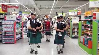 Newtonhill Pipe Band surprise shoppers in Asda Portlethen with performances in supermarket [upl. by Tirrag]